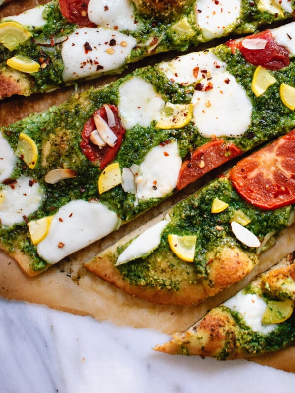 Homemade arugula-almond pesto pizza with a simple whole wheat crust