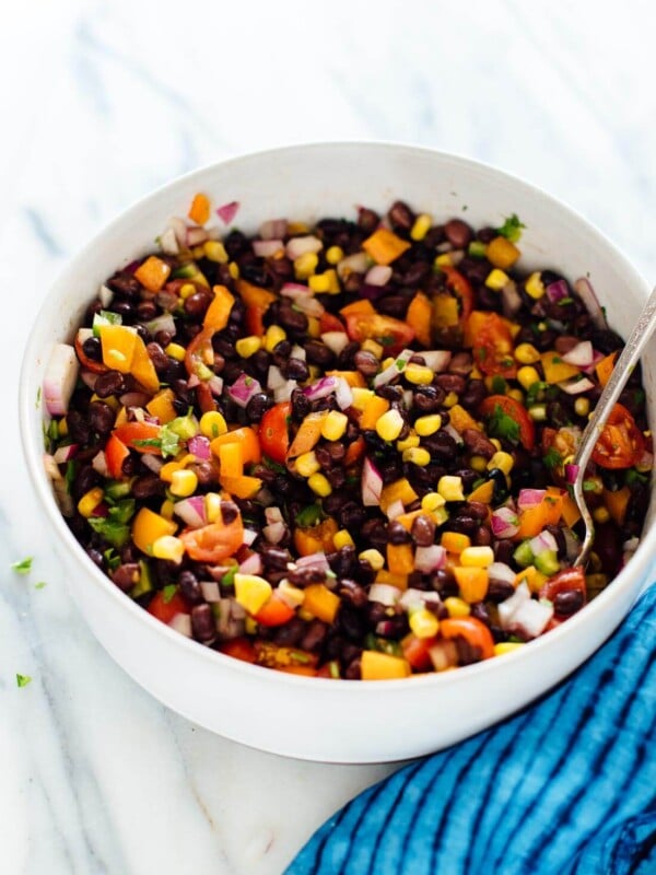 Perfect for parties and busy weeks! This fresh black bean salad recipe is as delicious as it is colorful. It's also vegan and gluten free. cookieandkate.com