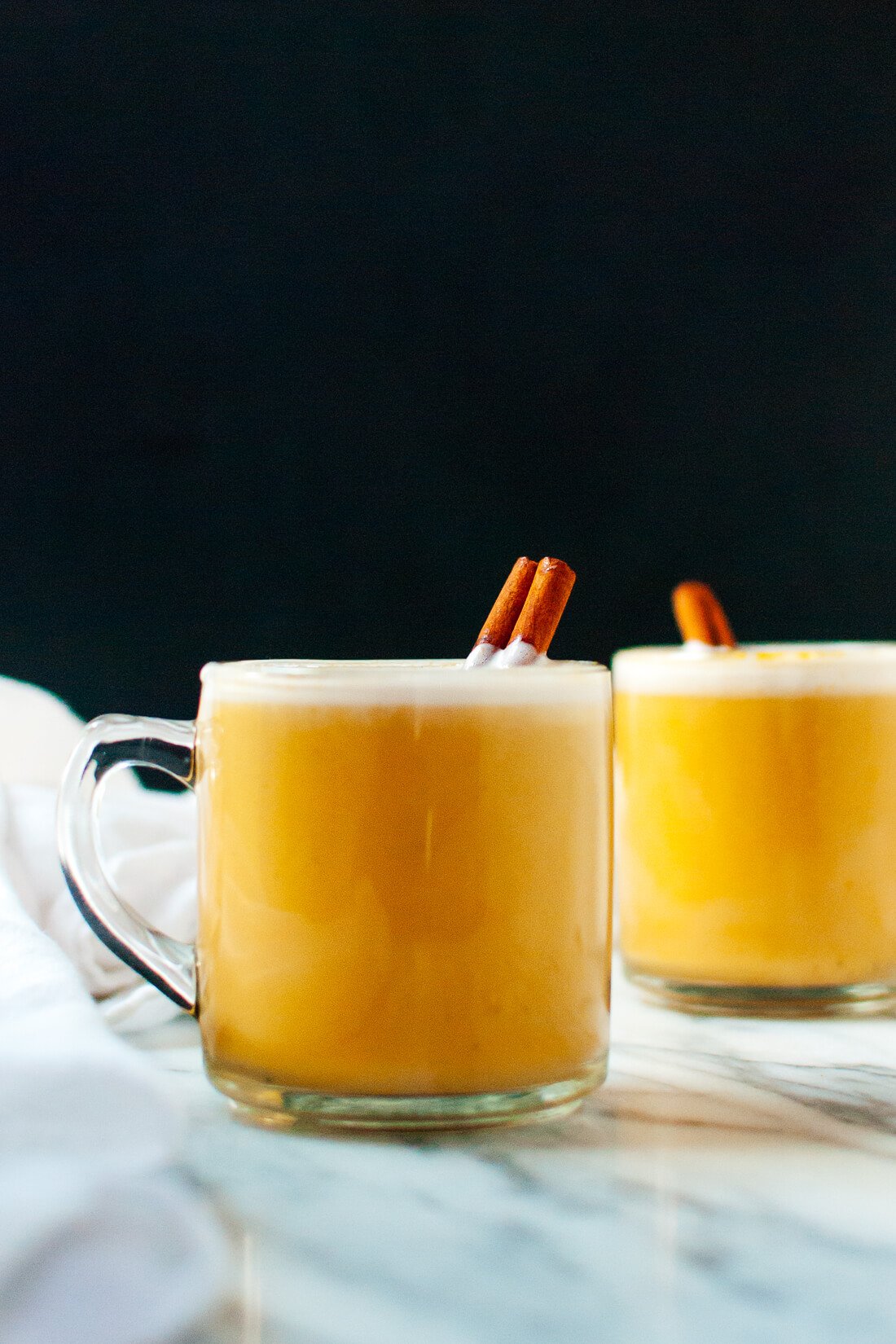 Homemade pumpkin chai lattes made with real pumpkin, almond milk, maple syrup and spices—rich and creamy, naturally sweetened and only 90 calories!