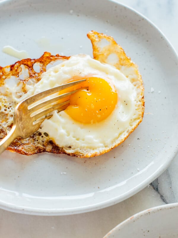 crispy fried egg oozing under fork