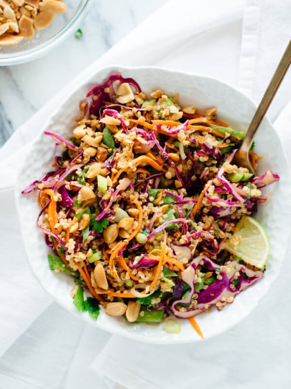 You're going to love this colorful, crunchy Thai peanut quinoa salad! It's made with carrots, cabbage, snow peas, and quinoa, tossed in a delicious peanut sauce. It packs great for lunch. Vegan and gluten free. cookieandkate.com