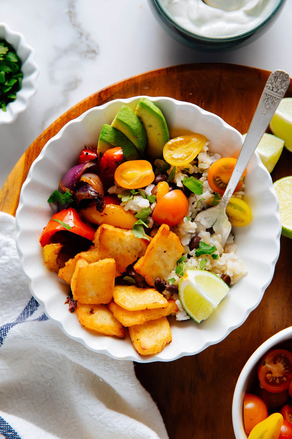 Vegetarian halloumi fajita bowl with black beans, rice, avocado and tomato