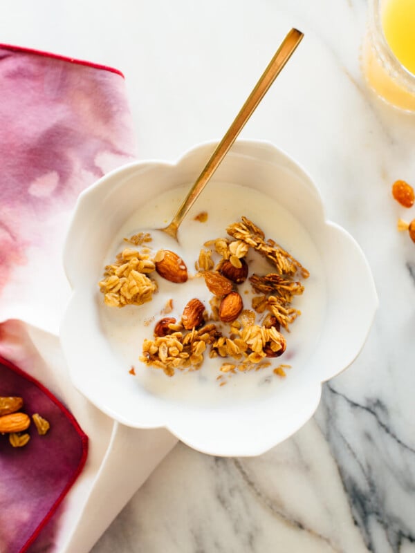 Orange almond granola in cereal bowl with milk